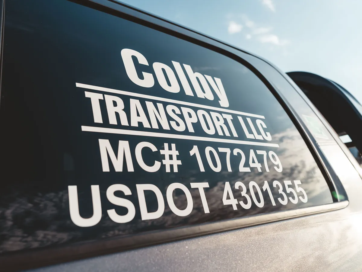 Colby Transport LLC window decal showing MC 1072479 and USDOT 4301355.